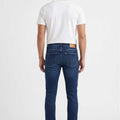 Men's skinny-fit dark blue jeans, back view with belt loops and pocket seams