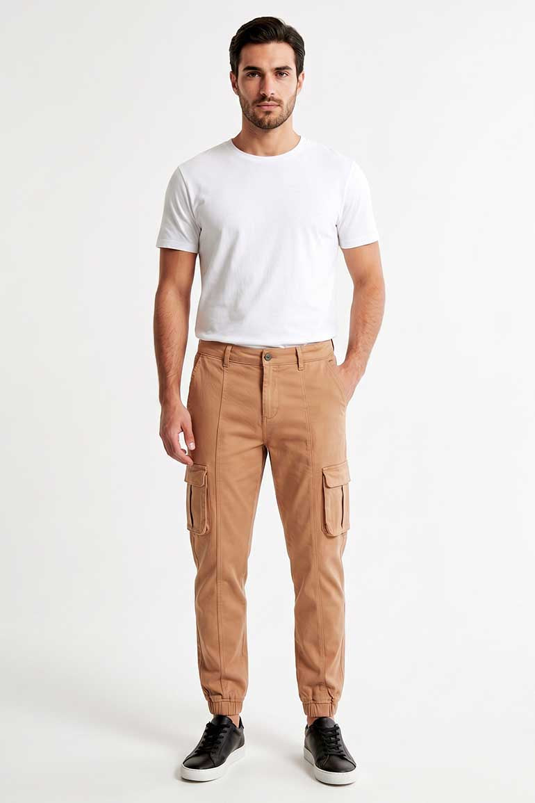 Men's tan cargo trousers on model with side cargo pockets and elastic ankle cuffs