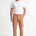 Men's tan cargo trousers on model with side cargo pockets and elastic ankle cuffs