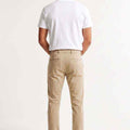 Men's slim-fit chinos in light beige, back view with waistband and rear yoke