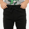 Black baby jogger trousers close-up: elastic waist with drawstring, tapered legs